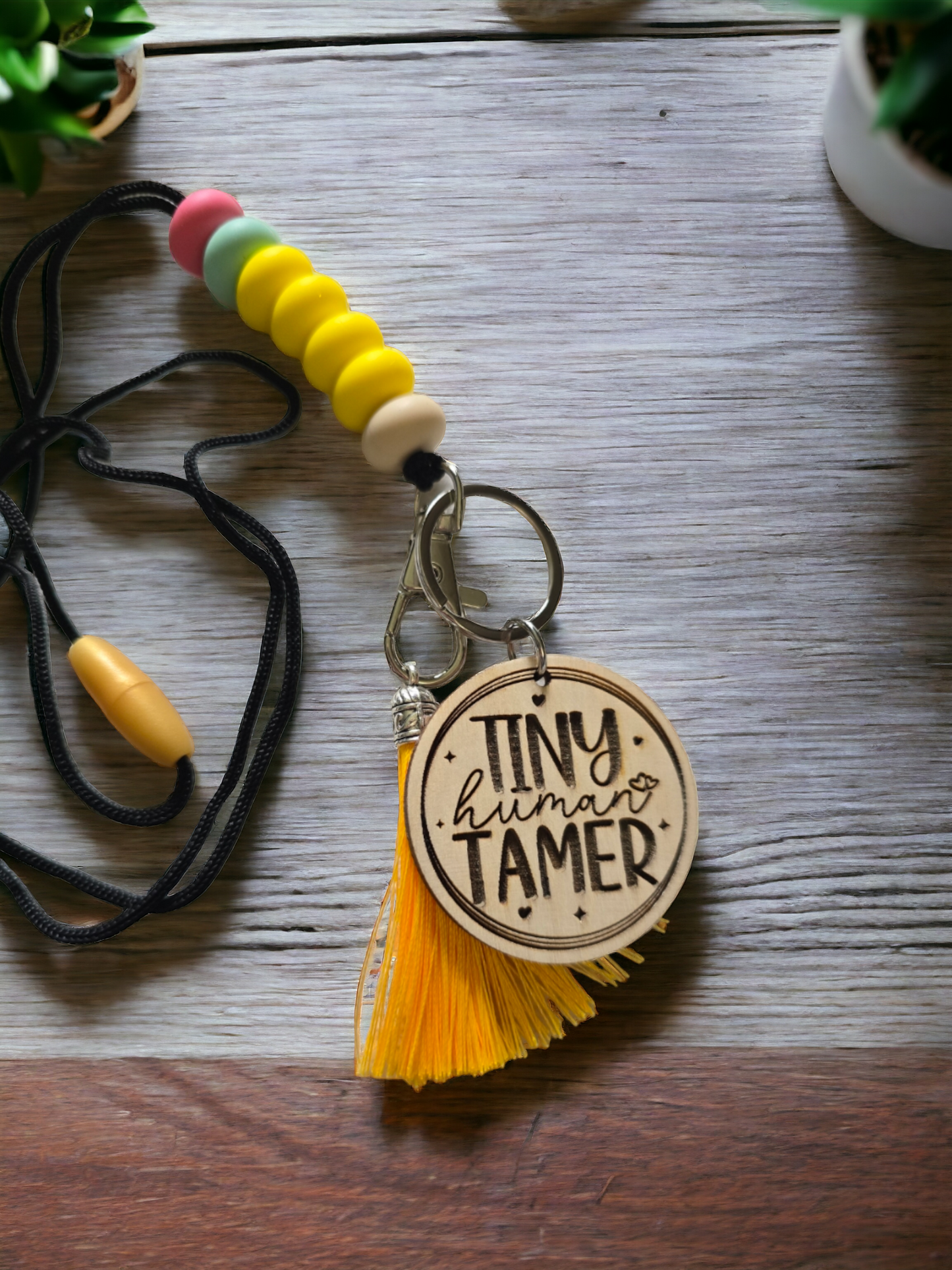 Tiny Human tamer Teacher lanyard resembles pencil