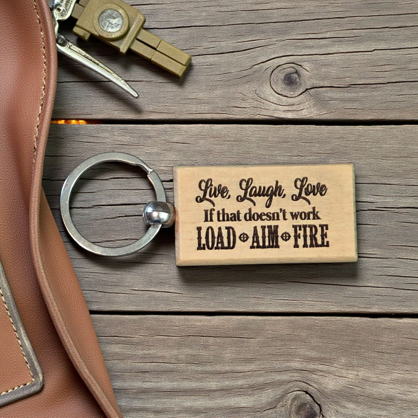 Live, laugh, love if that doesn't work load, aim, fire keychain