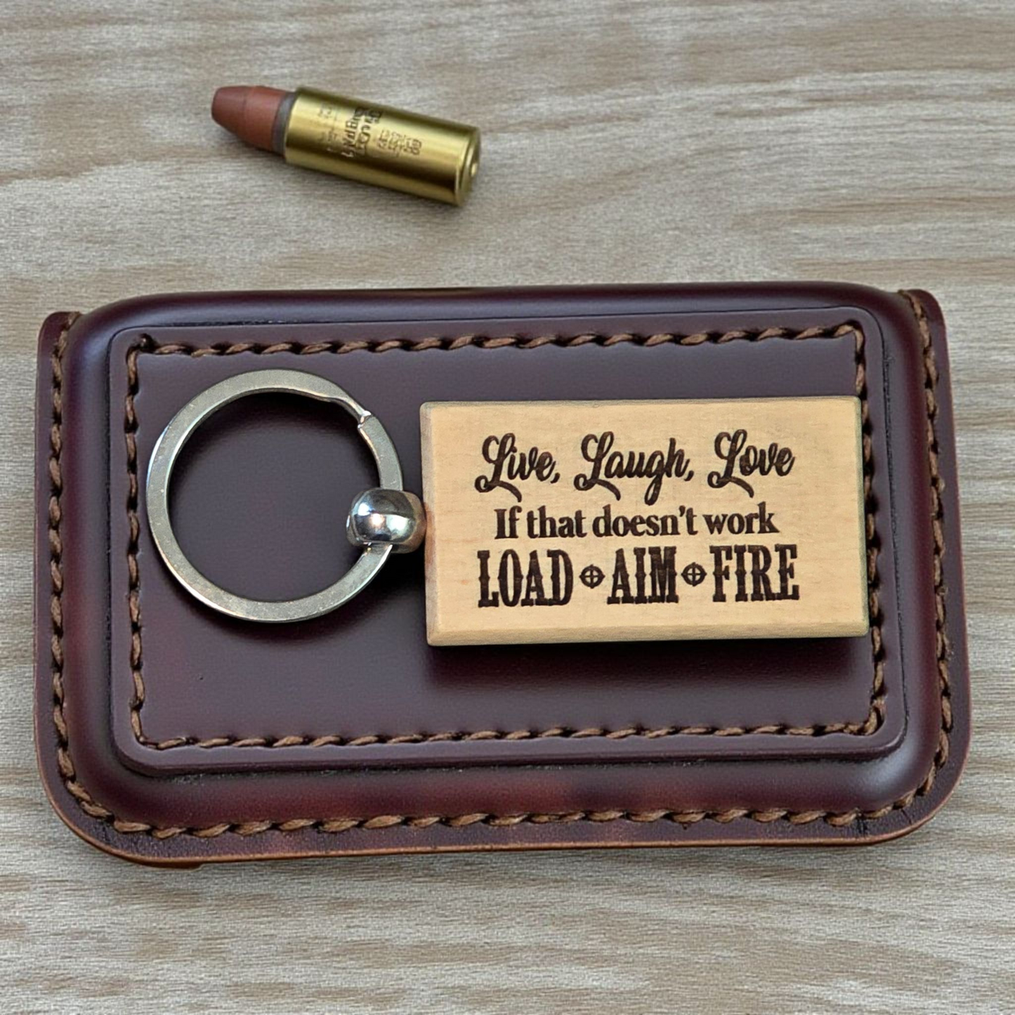 Live, laugh, love if that doesn't work load, aim, fire keychain